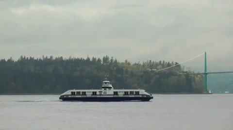 Vancouver Seabus Passing Stanley Park and Lions Gate Bridge Stock Footage 7744500