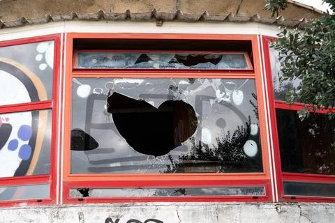 Vandalism concept. Building with Broken window and graffiti Vandalism conc... Stock Photos