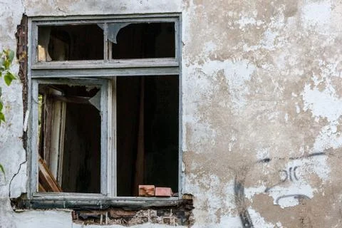 Vandalized abandoned stone old house with window Stock Photos