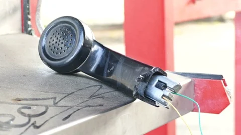 Vandalized payphone booth - Broken earphone Stock Footage 70867482