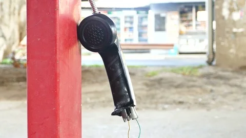 Vandalized payphone booth - Broken earphone Stock Footage 70868021