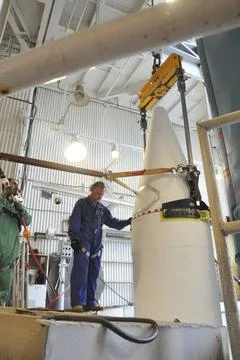 VANDENBERG AIR FORCE BASE, Calif. Workers in the mobile service tower at S... Stock Photos