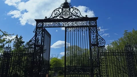 Vanderbilt Gate in Central Park Framed by Blue Sky and Clouds Tilt Down Stock Footage 336038475