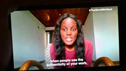 Vanessa Nakate interview about climate change, watching on iPhone Stock Footage 161909522