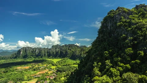 Vang Vieng, Laos, dramatic limestone karst mountains, overlooking vibrant green Stock Footage 318283242