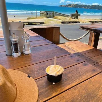 Vanilla bean Ice Cream on a table at the the seaside on a hot summers day Stock Photos