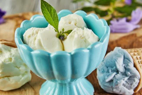 Vanilla, blueberry and raspberry ice cream in waffle cones and ice cream in cup Stock Photos