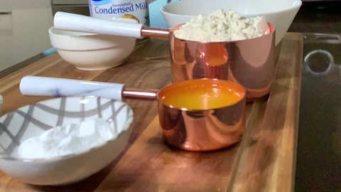 Vanilla cake ingredients on the kitcken table Stock Footage 136787918