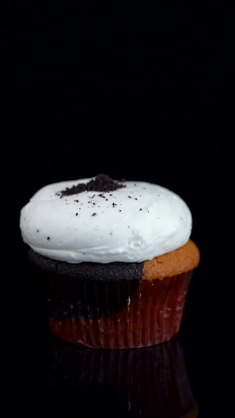 Vanilla Chocolate Cupcake with Cookie Crumbs Rotating on Reflective Surface Stock Footage 330516787