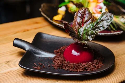 Vanilla-coconut mousse in the form of beets. Stock Photos