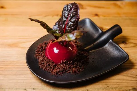 Vanilla-coconut mousse in the form of beets. Stock Photos