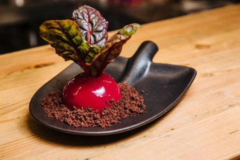 Vanilla-coconut mousse in the form of beets. Stock Photos