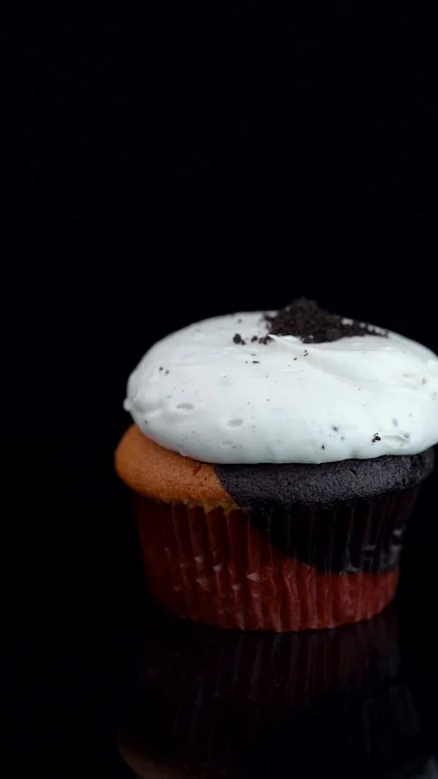 Vanilla Cupcake with Chocolate Cookie Crumbs Rotating on Black Background Stock Footage 330516789