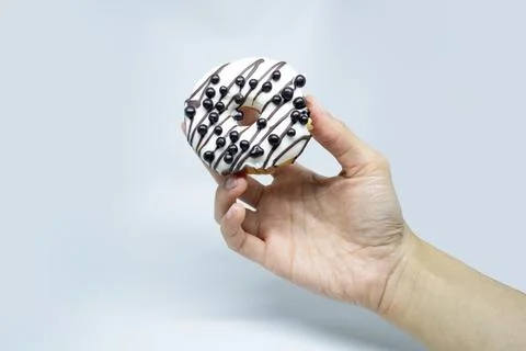 Vanilla donuts with choco chips on hold Stock Photos