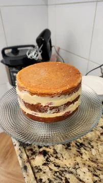 Vanilla filled cake made in the kitchen at home Stock Photos