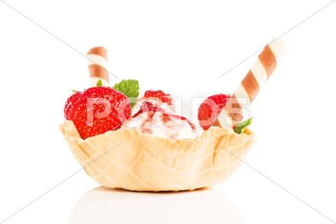 Vanilla ice cream with strawberries in a waffle cup Stock Photos