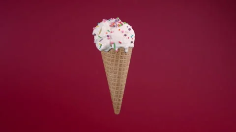Vanilla ice cream in waffle cone. Sweet dessert decorated with colorful Stock Footage 168404210
