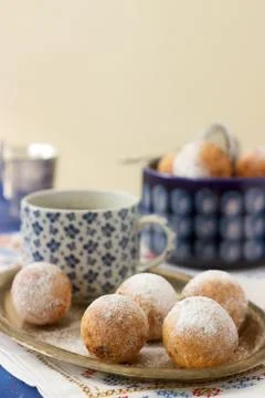 Vanilla krapfen doghnut with coffee. Rustic style. Stock Photos