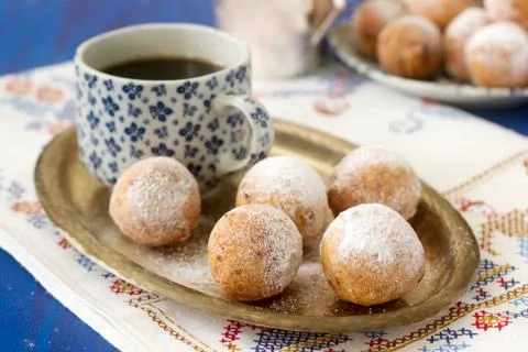 Vanilla krapfen doghnut with coffee. Rustic style. Stock Photos