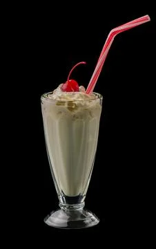 Vanilla milkshake and cherry isolated on black background Stock Photos