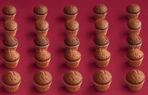 Vanilla mini muffins on a red background. Place for your text. Cupcake pattern Stock Photos
