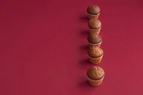 Vanilla mini muffins on a red background. Place for your text. Cupcake pattern Stock Photos