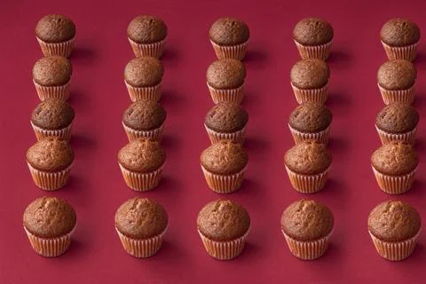 Vanilla mini muffins on a red background. Place for your text. Cupcake pattern Stock Photos