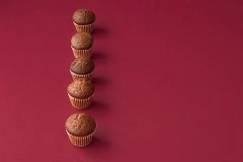Vanilla mini muffins on a red background. Place for your text. Cupcake pattern Stock Photos