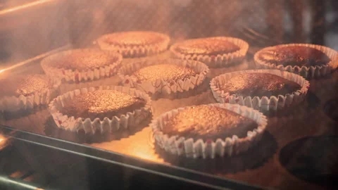 Vanilla Muffins are Cooked in the Oven, Rise and Brown Stock Footage 244333600