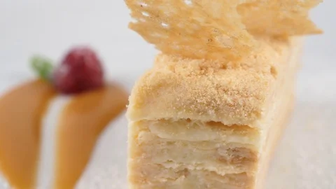 Vanilla or custard slice cake, served with icingsugar and raspberry 스톡 동영상 79986393