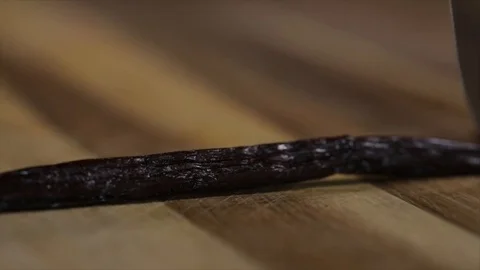 Vanilla Pod is cut open with a Knife closeup Stock Footage