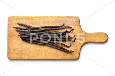 Vanilla pods on chopping board Stock Photos