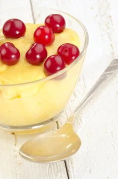 Vanilla pudding with cherry in a bowl Stock Photos