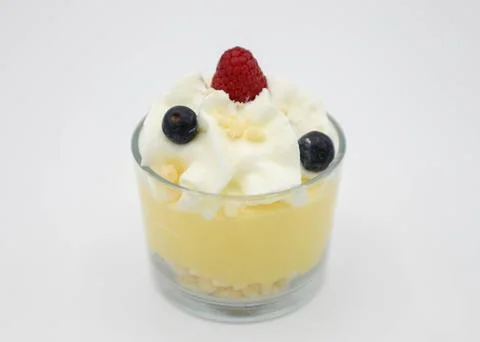 Vanilla pudding with whipped cream and fresh berries in a glass Stock Photos