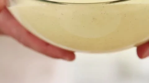 Vanilla sauce being sieved Stock Footage 24650820