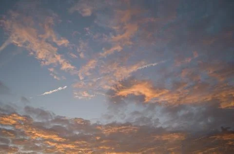 Vanilla sunset, gently pink clouds against the background of the sunset sky and Stock Photos