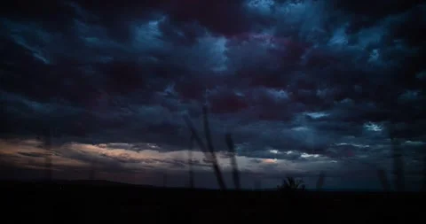 Vanishing rainbow under a stormy sky with distant highway traffic at twilight. 動画素材 277442003