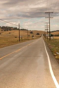 Vanishing viewpoint highway, storm clouds, wet pavement Stock Photos