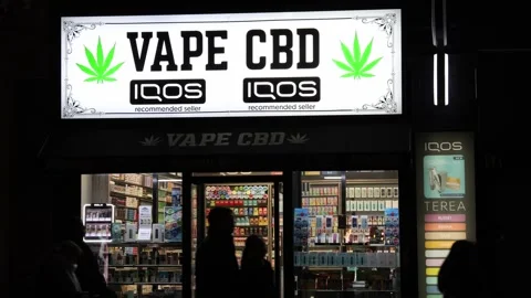 Vape and cbd store front exterior night shot. Video stock 325776023