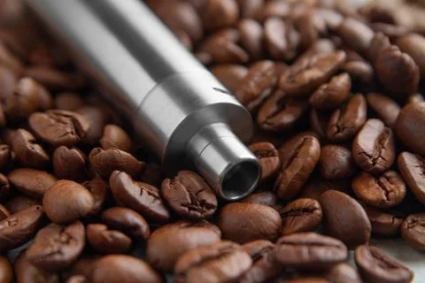Vape device on the background of coffee beans Stock Photos