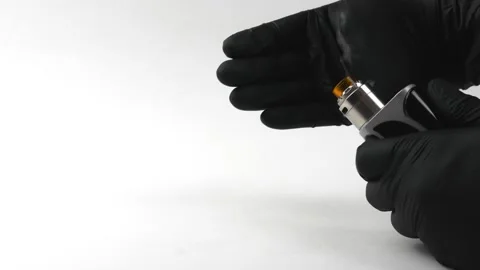 Vape device or electronic cigarette. Working electronic cigarette in hands. Video stock 131852543