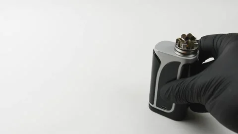 Vape device or electronic cigarette. Man holds an electronic cigarette. Video stock 131852677