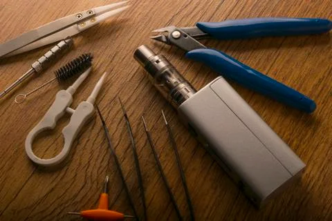 Vape device or electronic cigarette with vaping tools and accessories. Stock Photos