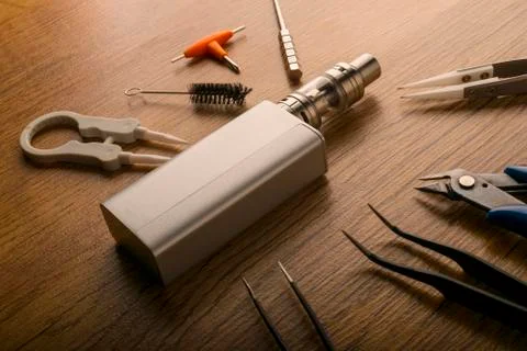 Vape device or electronic cigarette with vaping tools and accessories. Stock Photos