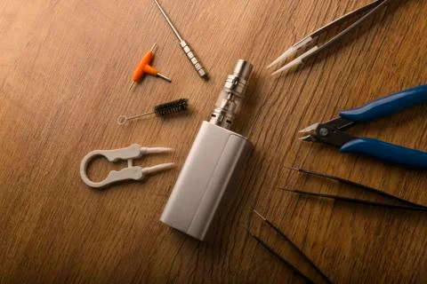 Vape device or electronic cigarette with vaping tools and accessories. Stock Photos