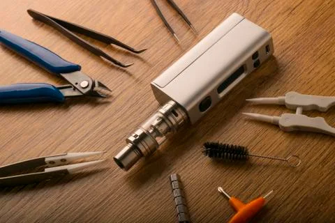 Vape device or electronic cigarette with vaping tools and accessories. Stock Photos