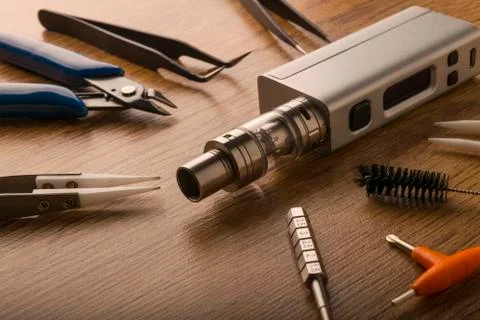 Vape device or electronic cigarette with vaping tools and accessories. Stock Photos