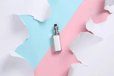 Vape device on pastel colored background with torn paper Stock Photos