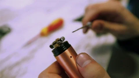 Vape. Male hands regulate electronic cigarette coils. Stock Footage 73178279