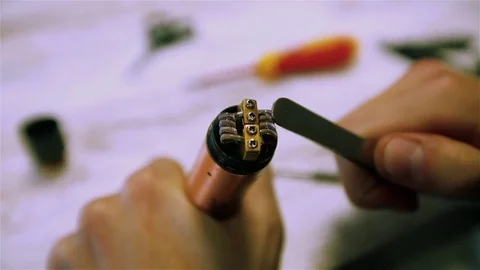 Vape. Male hands regulate electronic cigarette coils. Stock Footage 73178359